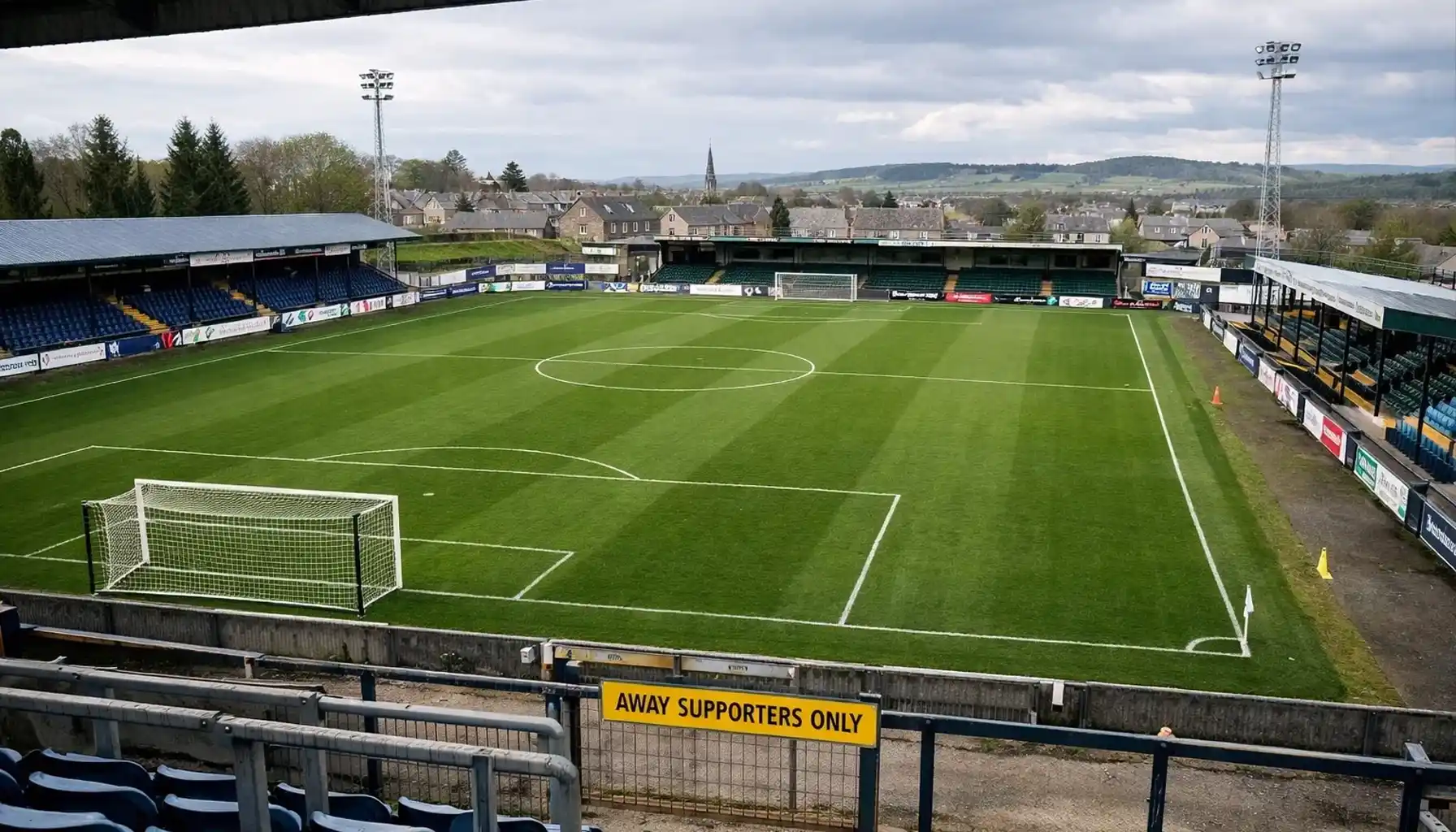 Football pitch at away ground with different stadium characteristics
